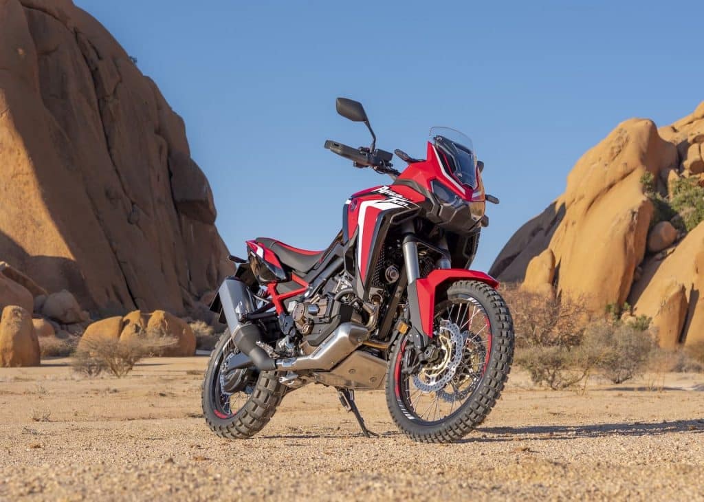 red and black Honda Africa Twin CRF1100L against rocks and blue sky