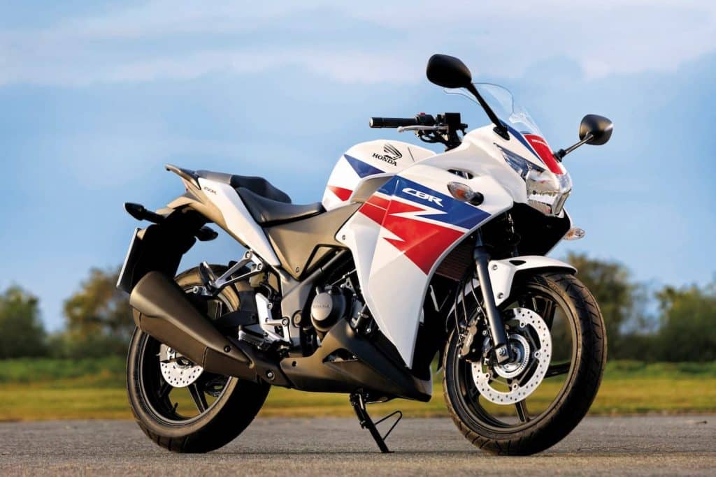 Honda CBR250R red white and blue on road