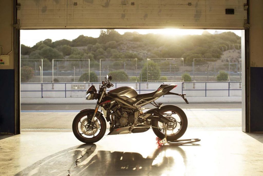 Triumph Street Triple RS parked at sunset in hangar