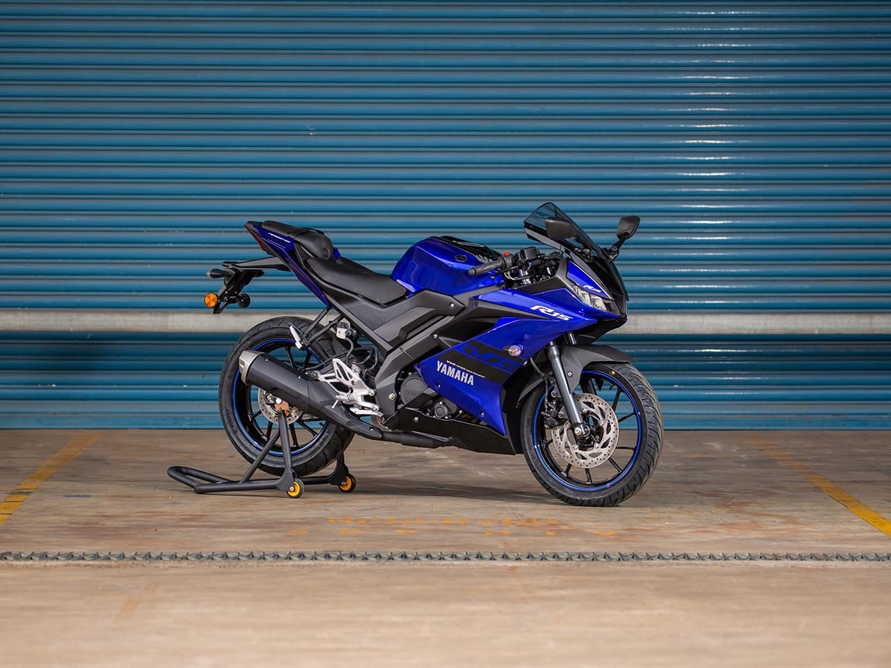 Yamaha YZF-R15 blue in front of wall