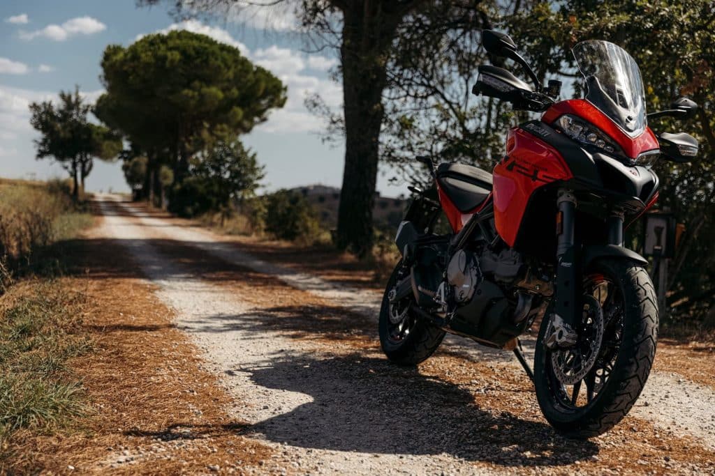 Red Ducati Multistrada V2S on country dirt road