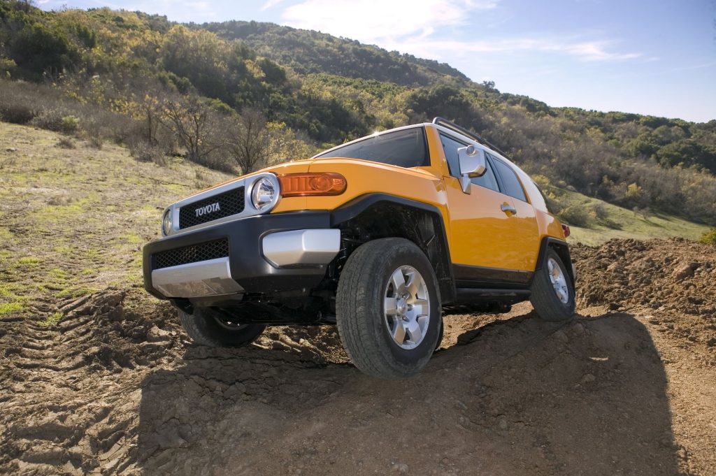 Toyota FJ Cruiser yellow climbing on rocks